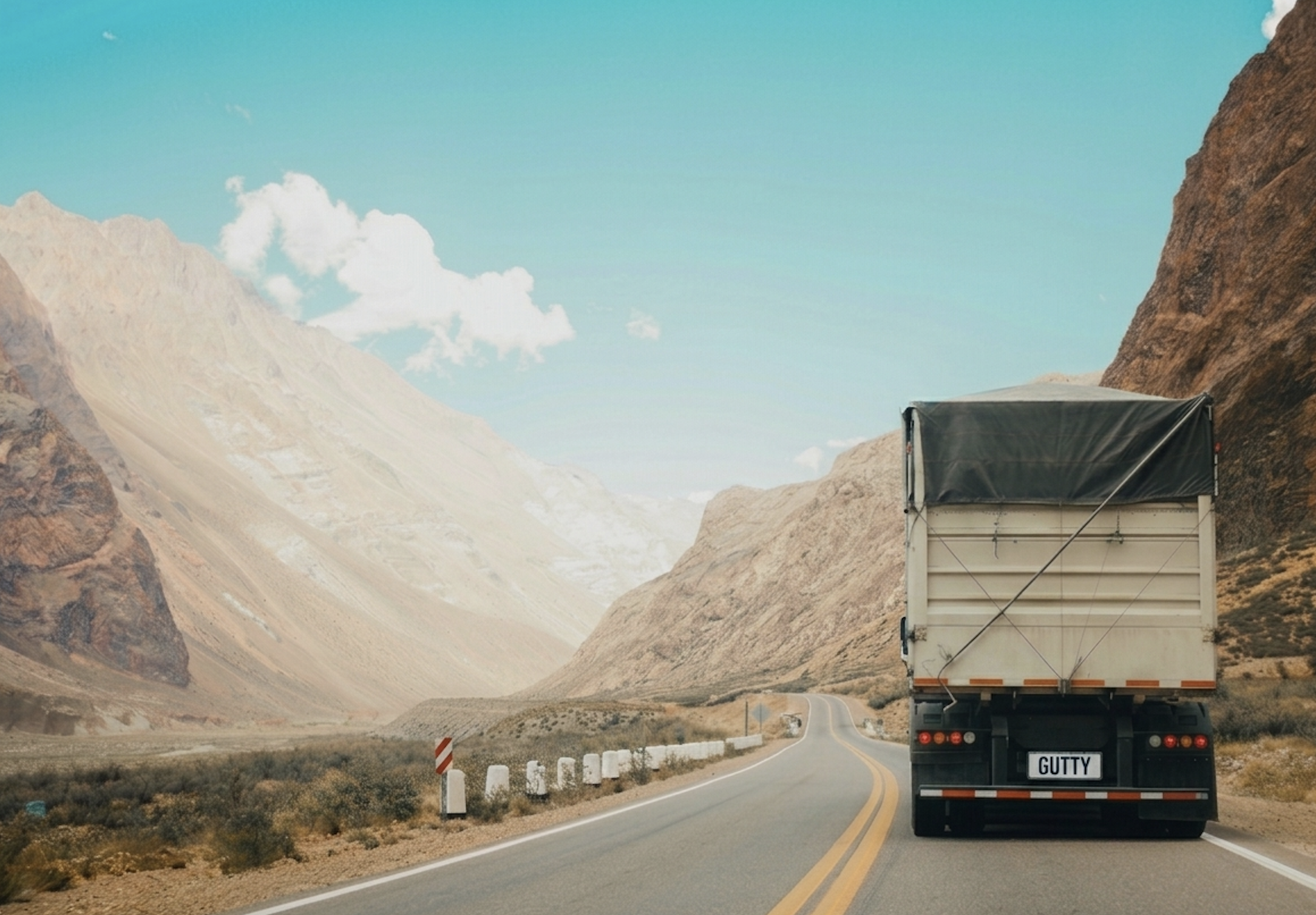 Gutty Trucking truck driving through a mountain highway